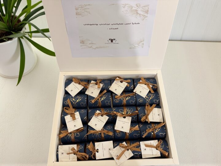 Gift set box filled with navy Belgian chocolate favor boxes and personalized tags