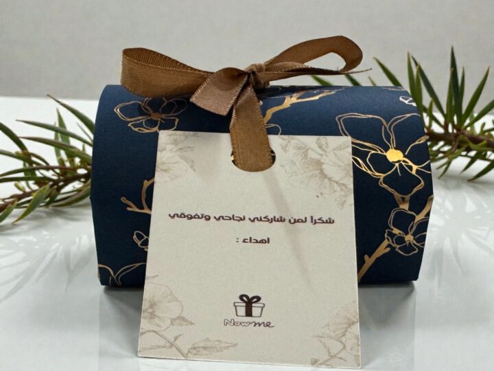 Navy Belgian chocolate favor box with personalized thank-you tag and brown ribbon